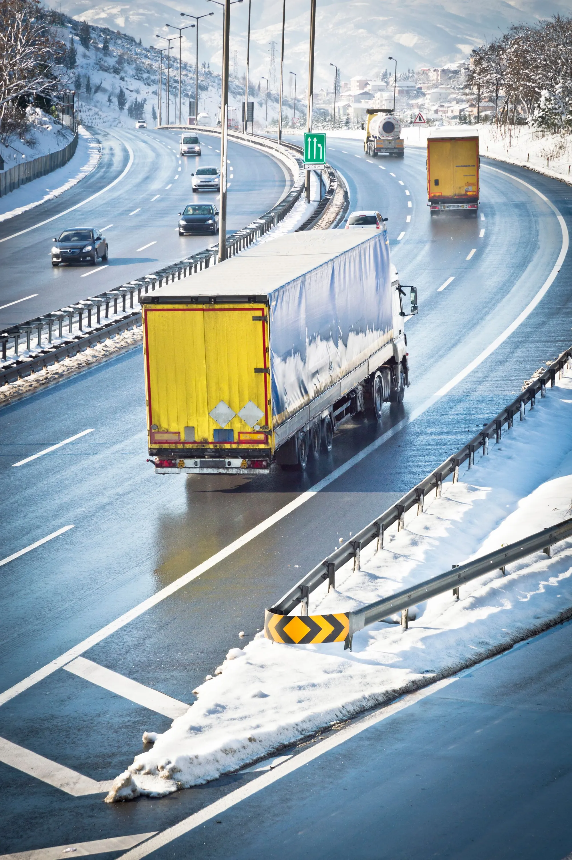 Freight truck travelling on a snow-covered highway